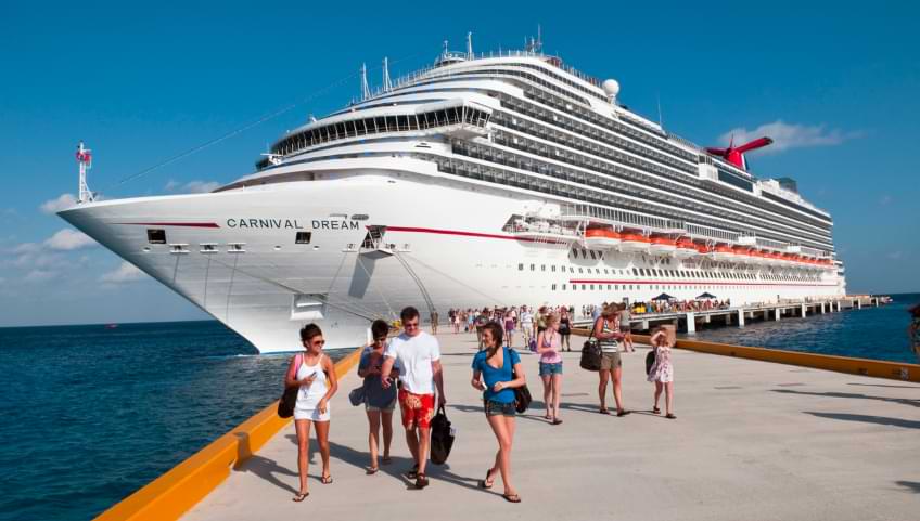 Passengers departing from cruise ship docked at a port